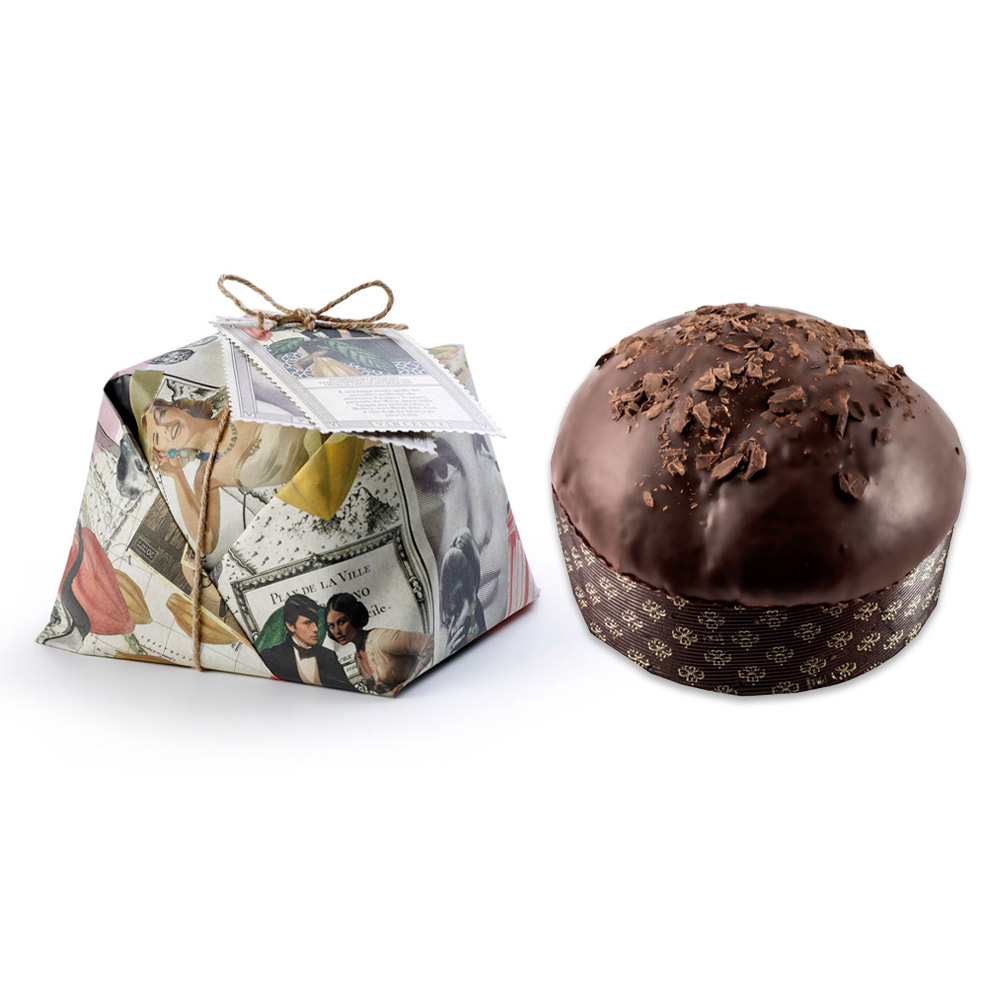 Vincente Delicacies Panettone "L'Attrice" Sguardi Siciliani ricoperto di Cioccolato di Modica e scaglie, farcito di Crema di Cioccolato di Modica IGP 900g - Il Panettone artigianale è senza dubbio il simbolo del Natale in tutte le case degli italiani. "L'Attrice", prodotto da Vincente Delicacies, si caratterizza per il suo impasto morbidissimo, arricchito da una farcitura golosa di crema di Cioccolato di Modica IGP e ricoperto di finissimo Cioccolato di Modica IGP e scaglie. L'elegante incarto avvolge un dolce tenero e profumato: ogni assaggio immerge il palato in un piacere dal gusto intenso e delicato. Questo Panettone artigianale incartato a mano fa parte della linea "Sguardi Siciliani", creata appositamente da Vincente Delicacies per celebrare la Sicilia, una terra ricca di tradizioni, tesori artistici e naturali: i suoi simboli sono famosi in tutto il mondo e rimandano a luoghi ricchi di folklore, feste pittoresche, buon cibo e storia. La linea "Sguardi Siciliani" è composta da otto tipologie di panettoni, ognuno dedicato a una figura rappresentativa della cultura siciliana, come artisti, scrittori, poeti , musicisti e tradizioni popolari, come Leonardo Sciascia, Antonello da Messina Luigi Pirandello fino ad arrivare al noto compositore Vincenzo Bellini.