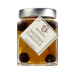 La Mostarda Classica è tradizionalmente composta da più tipi di frutta candita, tra cui albicocche, cedro, clementine, fichi, melone, ciliegie rosse e bianche e pere. Ogni frutto ha una diversa consistenza e grado di piccantezza. Si adatta particolarmente all'abbinamento con i formaggi stagionati o carni, ma è ottima anche gustata da sola o per esaltare alcune preparazioni culinarie.Grado di piccantezza generale: 9. Per le mostarde di frutta di Fredo vengono utilizzate solo le migliori materie prime di origine italiana. Fredo vanta una lunga storia di produzione artigianale di mostarda e frutta candita, iniziata nel lontano 1890 a Brissago (Canton Ticino). Prodotta in esclusiva per EnoArt Enoteca da Fredo SA nel laboratorio di Cadenazzo (Svizzera). Prodotto artigianale, lavorato e confezionato a mano. Formato: Vasetto 400g
