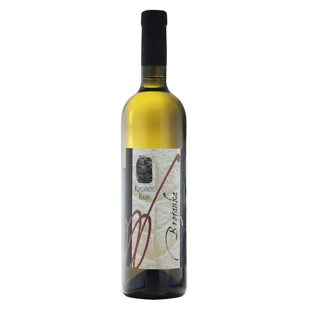 Brežanka (letteralmente "del Breg") di Kocjancic Rado è molto più di un vino bianco: è un sorso di storia del territorio triestino che recupera tradizioni del 1700. Nel calice si presenta di un colore giallo carico impreziosito da riflessi dorati. Il naso è un viaggio olfattivo ampio ed elegante: emergono note floreali di sambuco e acacia che si fondono con sentori di albicocca, pesca e uva passa, avvolti da un intrigante velo speziato di resina e caramello. Al palato è complesso, avvolgente e armonico, marcato da una profonda sapidità e un retrogusto speziato di lunghissima persistenza. - L'anima di questo vino risiede nel suo uvaggio straordinario: un assemblaggio di 15 varietà a bacca bianca provenienti da una singola vigna centenaria a filari stretti, dove ogni lavorazione è manuale e la resa è inferiore a 1kg per pianta. Qui convivono vitigni autoctoni (Malvasia Istriana, Vitovska, Glera), varietà del Collio e della Valle del Vipava (tra cui Friulano, Riesling, Ribolla, Klarnca) e persino antiche viti a piede franco non ancora mappate geneticamente. - La vinificazione è un inno alla naturalità e all'artigianato: vendemmia tardiva manuale, fermentazione spontanea con lieviti indigeni senza controllo della temperatura e macerazione sulle bucce (orange wine). Senza aggiunta di solforosa, il vino matura in grandi botti di rovere di Slavonia per poi affinare a lungo in bottiglia. Un vino di struttura e meditazione, capace di sfidare il tempo.